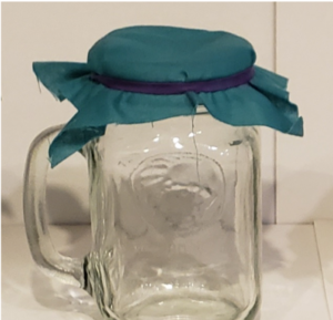 Photo of a mason jar covered with a piece of cotton for the DIY mask test of water resistance